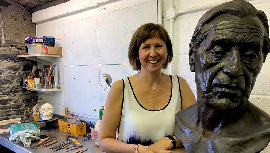 Elizabeth standing beside a completed bust