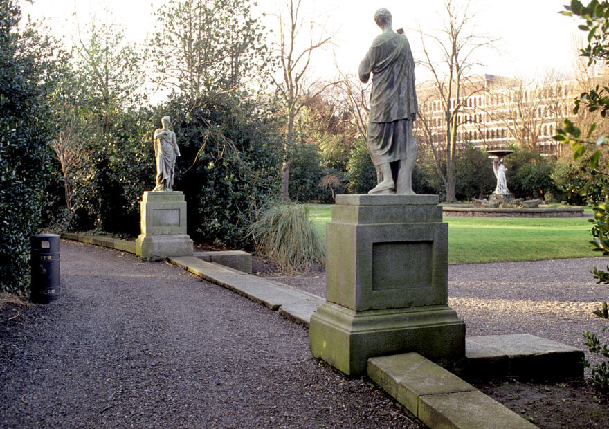 two tall statues face each other over the steps if the iveagh gardens