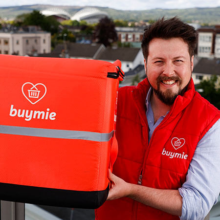 buymie worker, a company supported by the hpsu, in red bodywarmer