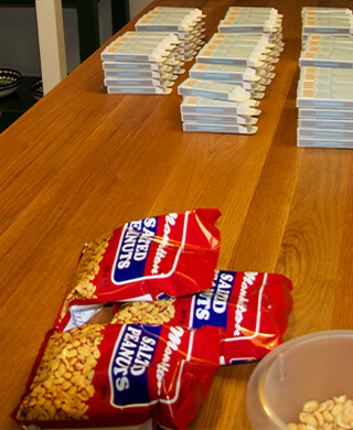 manhattan peanuts sit on a wooden countertop