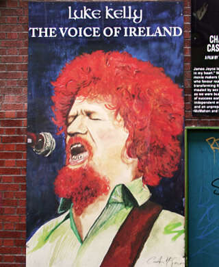 a colourful mural of luke kelly which appears on the icon walk