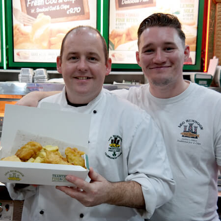 two staff members at leo burdocks wear white chef's jackets