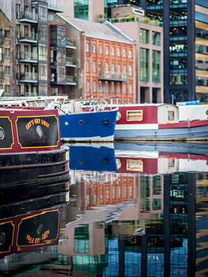 three colourful canal barges moored at grand canal dock