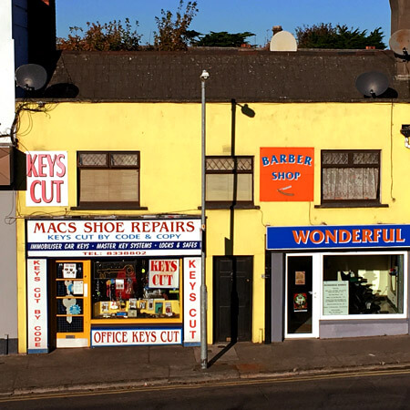 yellow houses with blue and white shop fronts