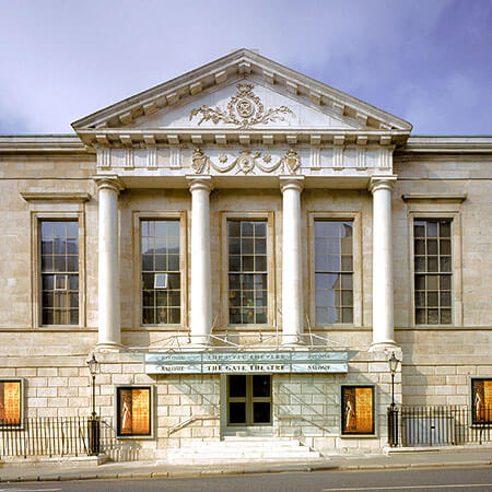the stone, neo-classical style facade of the gate theatre