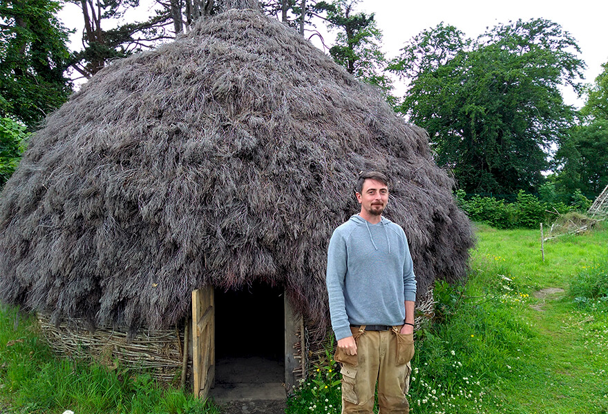 Experiential learning: PhD student Brendan O'Neill outside the roundhouse he constructed.