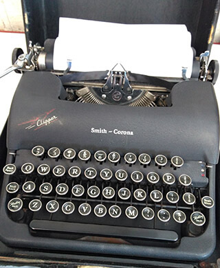 a black matt smith corona portable typewriter
