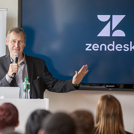 Colum Twomey stands on stage with a mic at zendesk in dublin
